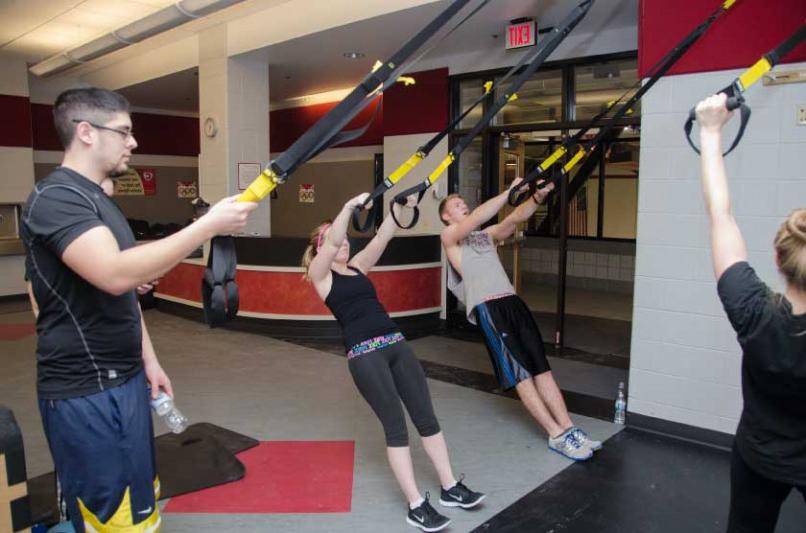 Students use the TRX Suspension Trainer in the TARC's Semler Fitness Center in January 2014. TRX ...